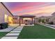 The backyard boasts artificial turf, a covered structure, and a paved walkway at 4152 W Bradshaw Creek Ln, New River, AZ 85087