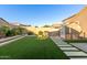 The landscaped backyard features artificial turf, a grill, and storage shed at 4152 W Bradshaw Creek Ln, New River, AZ 85087