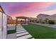 Backyard with an outdoor gym under a pergola, and a garden area with artificial grass at 4152 W Bradshaw Creek Ln, New River, AZ 85087