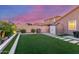 The landscaped backyard features artificial turf, a grill, storage shed, and hardscaped pavers at 4152 W Bradshaw Creek Ln, New River, AZ 85087