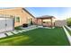 This backyard features artificial turf, a covered structure, and hardscaped pavers at 4152 W Bradshaw Creek Ln, New River, AZ 85087