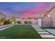 The landscaped backyard is complete with artificial turf, a grill, and storage shed at 4152 W Bradshaw Creek Ln, New River, AZ 85087