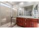 Bright bathroom showcasing a glass enclosed shower with a built-in bench and a vanity with double sinks at 4152 W Bradshaw Creek Ln, New River, AZ 85087