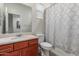 Bathroom featuring a single sink vanity, a standard toilet and a shower/tub combination with a curtain at 4152 W Bradshaw Creek Ln, New River, AZ 85087