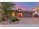 Charming single-story home with a paver driveway and a two-car garage at dusk at 4152 W Bradshaw Creek Ln, New River, AZ 85087