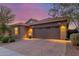 Home exterior featuring a brick paver driveway and desert landscaping at 4152 W Bradshaw Creek Ln, New River, AZ 85087