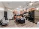 Well-lit kitchen featuring stainless appliances, an island with seating, and ample counter space at 4152 W Bradshaw Creek Ln, New River, AZ 85087
