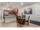 Eat-in kitchen with stainless steel appliances, wood cabinets, and a glass dining table at 4152 W Bradshaw Creek Ln, New River, AZ 85087