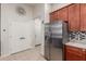 A view of kitchen with stainless steel refrigerator and double doors leading to other rooms at 4152 W Bradshaw Creek Ln, New River, AZ 85087
