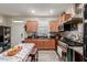 Charming kitchen featuring modern appliances, dark countertops and a cozy dining area at 4152 W Bradshaw Creek Ln, New River, AZ 85087
