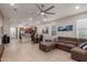 Open-concept living area with tile floors, a ceiling fan, and a view into the kitchen and dining area at 4152 W Bradshaw Creek Ln, New River, AZ 85087