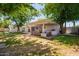 Spacious backyard offers a large covered patio and lush lawn with mature trees at 4238 E Mitchell Dr, Phoenix, AZ 85018