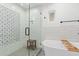 Elegant bathroom featuring a glass-enclosed shower, soaking tub, and stylish tile accents at 4238 E Mitchell Dr, Phoenix, AZ 85018