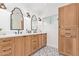 Stylish bathroom featuring a double sink vanity, custom mirrors, and wood cabinetry at 4238 E Mitchell Dr, Phoenix, AZ 85018