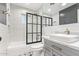 Modern bathroom with subway tile, black framed shower, and vessel sink with marble countertop at 4238 E Mitchell Dr, Phoenix, AZ 85018