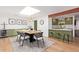 Open-concept dining area with modern lighting, skylight, and seamless flow to the kitchen at 4238 E Mitchell Dr, Phoenix, AZ 85018