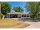 Traditional-style home with a carport and spacious driveway, surrounded by mature landscaping at 4238 E Mitchell Dr, Phoenix, AZ 85018