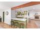 Stylish kitchen with a breakfast bar, updated appliances, and a view into the dining area at 4238 E Mitchell Dr, Phoenix, AZ 85018