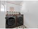 Well-organized laundry room featuring modern washer and dryer units with stylish tile flooring at 4238 E Mitchell Dr, Phoenix, AZ 85018
