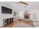 Bright living room featuring backyard access, ceiling fan, modern decor, and wood floors at 4238 E Mitchell Dr, Phoenix, AZ 85018