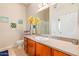 Bathroom vanity with a granite countertop and a large mirror, enhancing the functionality and style of the space at 424 S 2Nd St # 203, Phoenix, AZ 85004