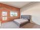 Bedroom with a brick accent wall, complemented by an industrial duct, showcasing a blend of textures and modern design at 424 S 2Nd St # 203, Phoenix, AZ 85004