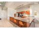 Open kitchen with stainless steel appliances, breakfast bar with seating, and ample counter space at 424 S 2Nd St # 203, Phoenix, AZ 85004