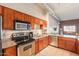 Well-equipped kitchen with stainless steel appliances, and ample counter space with wood cabinets at 424 S 2Nd St # 203, Phoenix, AZ 85004