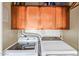 Laundry area with a washer and dryer under storage cabinets, maximizing space and efficiency at 424 S 2Nd St # 203, Phoenix, AZ 85004
