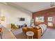 Cozy living room showcasing a exposed brick wall, and door that leads to the balcony at 424 S 2Nd St # 203, Phoenix, AZ 85004