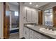 Luxurious bathroom with a double-sink vanity and a bathtub and shower in the background at 4327 E Capricorn Pl, Chandler, AZ 85249