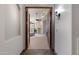 Bedroom entrance with open double wood doors, and a hallway with tile flooring at 4327 E Capricorn Pl, Chandler, AZ 85249