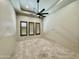 A light and airy bedroom featuring a ceiling fan and natural light filtering through wood shuttered windows at 4327 E Capricorn Pl, Chandler, AZ 85249
