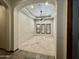 Spacious carpeted bedroom showcasing arched entryway and neutral tones, enhanced by natural light through shuttered windows at 4327 E Capricorn Pl, Chandler, AZ 85249