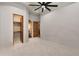 Spacious bedroom with neutral carpet, ceiling fan, and doorways to closet and bathroom at 4327 E Capricorn Pl, Chandler, AZ 85249