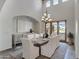 Elegant dining room with high ceilings, a modern chandelier, and seating for eight at 4327 E Capricorn Pl, Chandler, AZ 85249