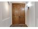 Hallway view of beautiful arched double wood doors and sconce lighting at 4327 E Capricorn Pl, Chandler, AZ 85249