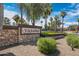 Stone community entrance sign with manicured landscaping and American flags at 4327 E Capricorn Pl, Chandler, AZ 85249