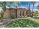 Beautiful single-story home featuring stone detailing, arched windows, a tile roof, and a well-manicured lawn at 4327 E Capricorn Pl, Chandler, AZ 85249