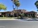 Expansive single-story home with stone veneer, arched entryways, a tile roof, mature palms, and green lawn at 4327 E Capricorn Pl, Chandler, AZ 85249