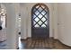 Grand foyer showcasing a decorative wooden door with glass inserts and tiled flooring at 4327 E Capricorn Pl, Chandler, AZ 85249