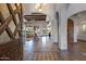 Spacious foyer with arched doorways, wood ceiling beams, and travertine floors at 4327 E Capricorn Pl, Chandler, AZ 85249