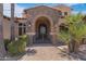 Elegant front entryway with gated access, stone archway, and lush landscaping at 4327 E Capricorn Pl, Chandler, AZ 85249
