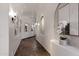 Arched hallway with sconce lighting, artwork, and dark tile flooring at 4327 E Capricorn Pl, Chandler, AZ 85249