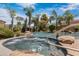 Sparkling hot tub surrounded by rocks and mature landscaping, offering a private spa experience at 4327 E Capricorn Pl, Chandler, AZ 85249