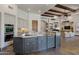 Open kitchen with a granite countertop island, modern appliances, and an open floor plan with exposed wood beams at 4327 E Capricorn Pl, Chandler, AZ 85249
