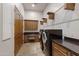 An efficient laundry room equipped with modern appliances, custom cabinets and countertops and tiled floors at 4327 E Capricorn Pl, Chandler, AZ 85249