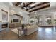 Spacious living room with fireplace, stone floors, large windows, and neutral decor creating a bright atmosphere at 4327 E Capricorn Pl, Chandler, AZ 85249