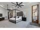 Spacious main bedroom with a four-poster bed, neutral decor, and an exterior door at 4327 E Capricorn Pl, Chandler, AZ 85249