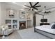 Bedroom with a fireplace, built-in shelving, a four-poster bed, and a ceiling fan at 4327 E Capricorn Pl, Chandler, AZ 85249